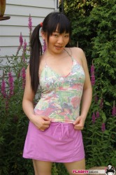 Pigtailed Chinese Babe In Skirt Poses Outdoor